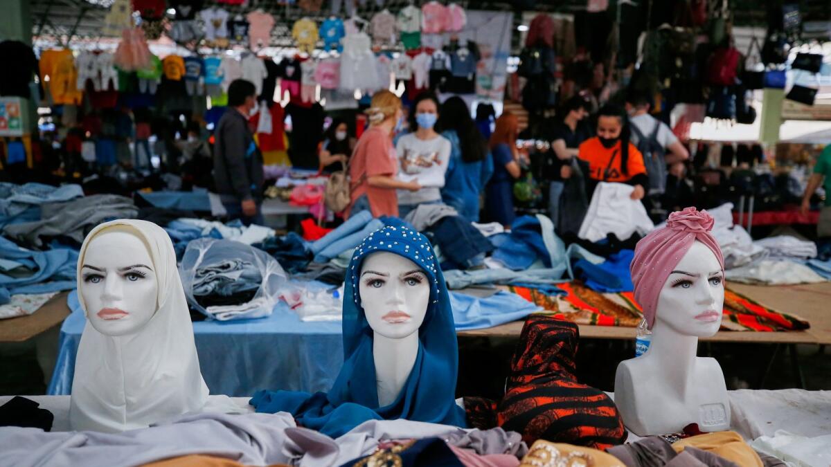 Women shop at a street market ahead of a nationwide 'full closure' to prevent the spread of the coronavirus disease in Ankara on Thursday.