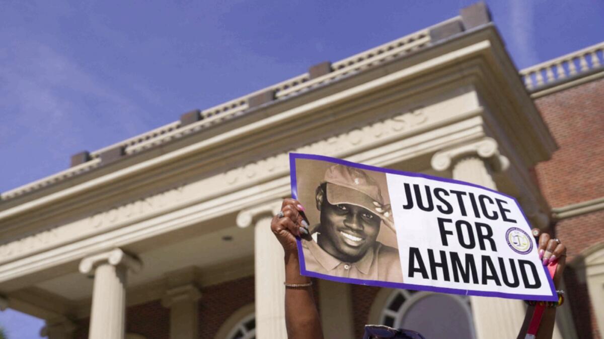 A demonstrator holds a sign at the Glynn County Courthouse last year during the trial of the shooting death of Ahmaud Arbery. — AFP file