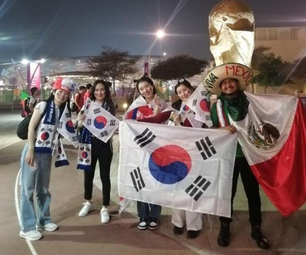 Mexican fan Jesus with a group of South Korean fans. -- Supplied photo