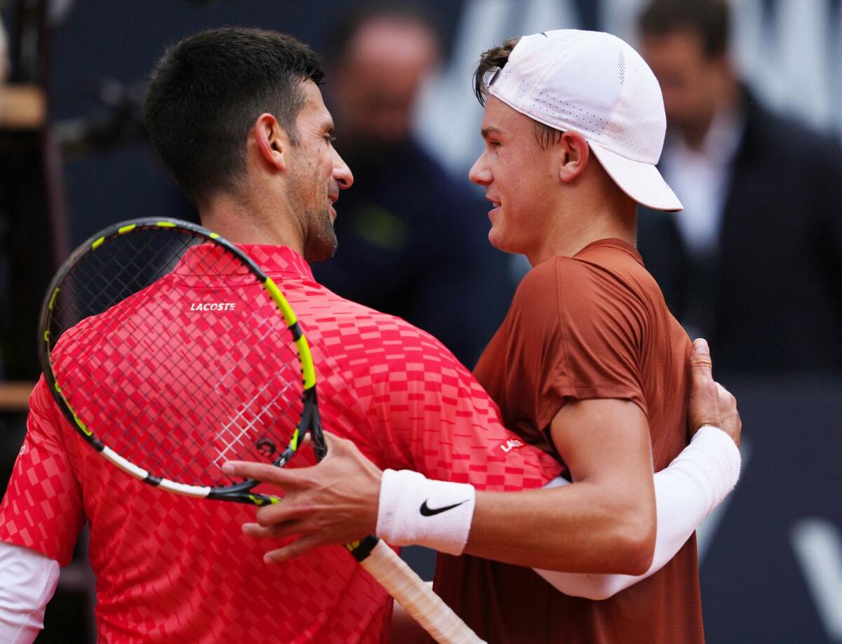 Denmark's Holger Rune with Serbia's Novak Djokovic after winning his quarter final. Photo: Reuters
