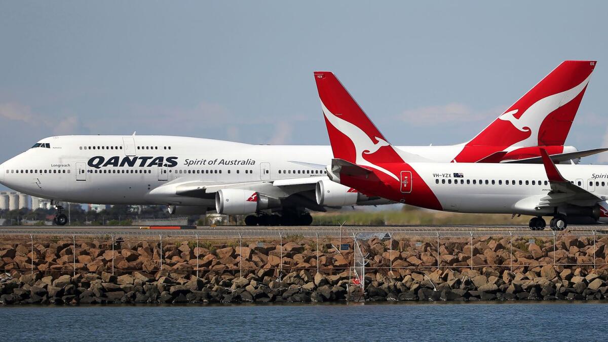 Two Qantas planes taxi on the runway at Sydney Airport. The Australian government will provide financial support to Qantas and Virgin Airways between April 1 and October 31 — when international flights are expected to resume. — AP