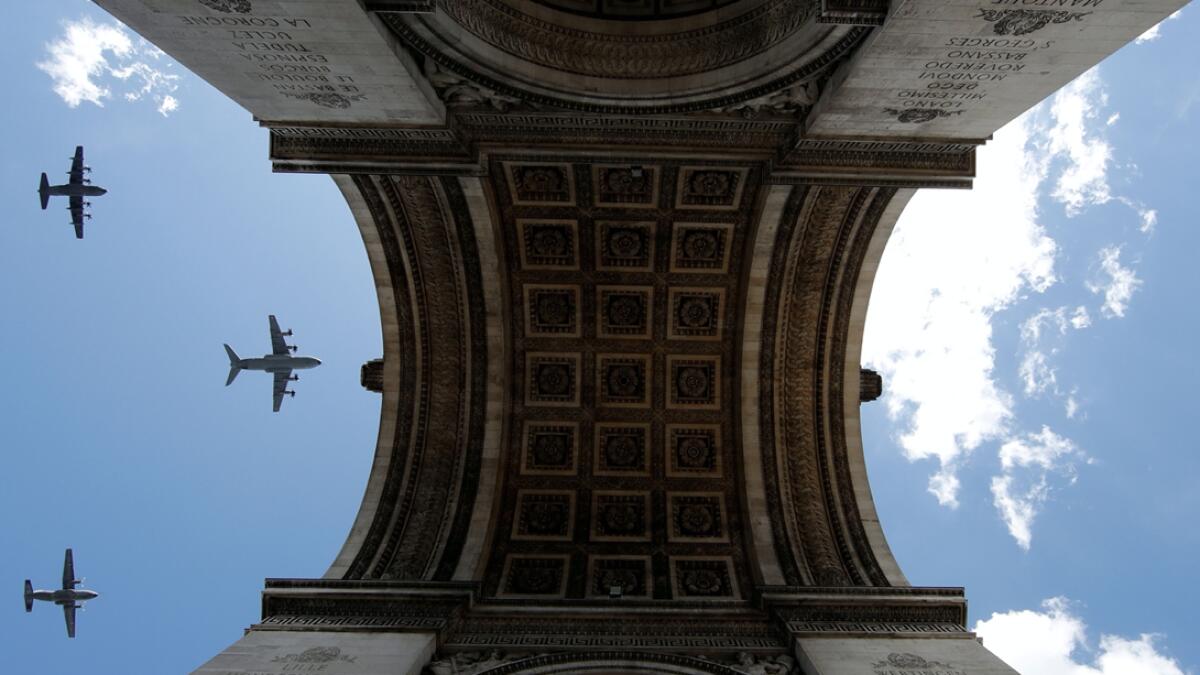 Military aircrafts fly over the Arc de Triomphe during a rehearsal for the Bastille Day celebrations in Paris, France. Photo: Reuters