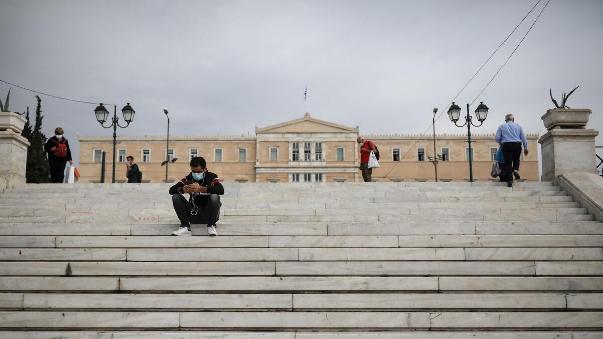 People wearing protective face masks are seen on Syntagma square, amid the coronavirus disease (COVID-19) pandemic, in Athens, Greece, November 3, 2020.