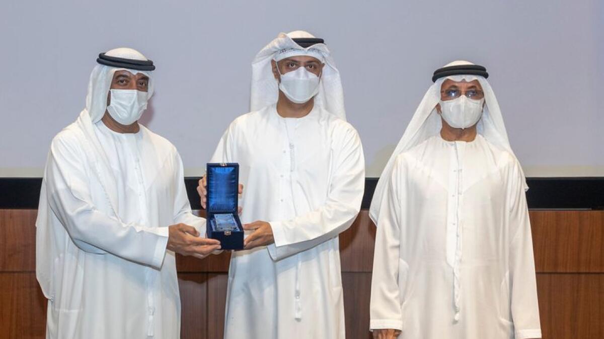 Abdulla Al Nuaimi, receives award from Sheikh Ahmed bin Saeed Al Maktoum, accompanied by Sultan Ahmed bin Sulayem. — Supplied photo