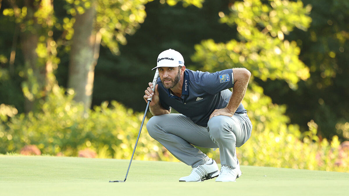 Dustin Johnson lines up a putt on the 18th green during the third round of The Northern Trust Open in Norton, Massachusetts. -- AFP