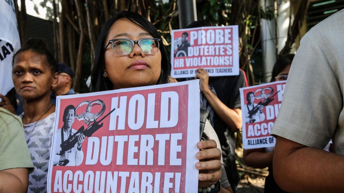 Supporters of Philippine lawmaker France Castro hold a noise barrage before the preliminary investigation of her grave threat complaint filed against former Philippine President Rodrigo Duterte outside the Prosecutor’s Office in Quezon City, Metro Manila on December 4, 2023.  (Photo by AFP)