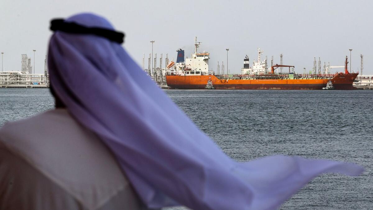 An Emirati man looks on at the port of Fujairah in the Gulf Emirate, on May 13, 2019. (Photo by KARIM SAHIB / AFP)