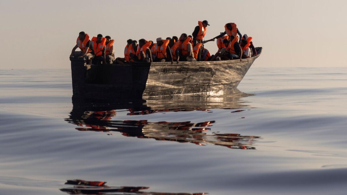 Migrants with life jackets provided by volunteers of the Ocean Viking, a migrant search and rescue ship, sit in a wooden boat before being rescued  on Aug. 27. — AP file photo used for illustrative purpose only