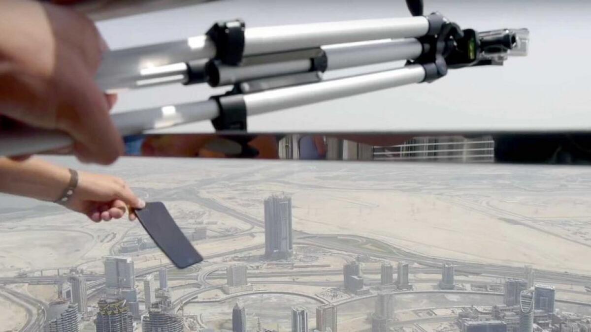 A screengrab from the video shot by a Ukrainian in which he drops a brand new iPhone from the 148th floor of Burj Khalifa. Police have made him sign an undertaking that he would never do such a thing again.