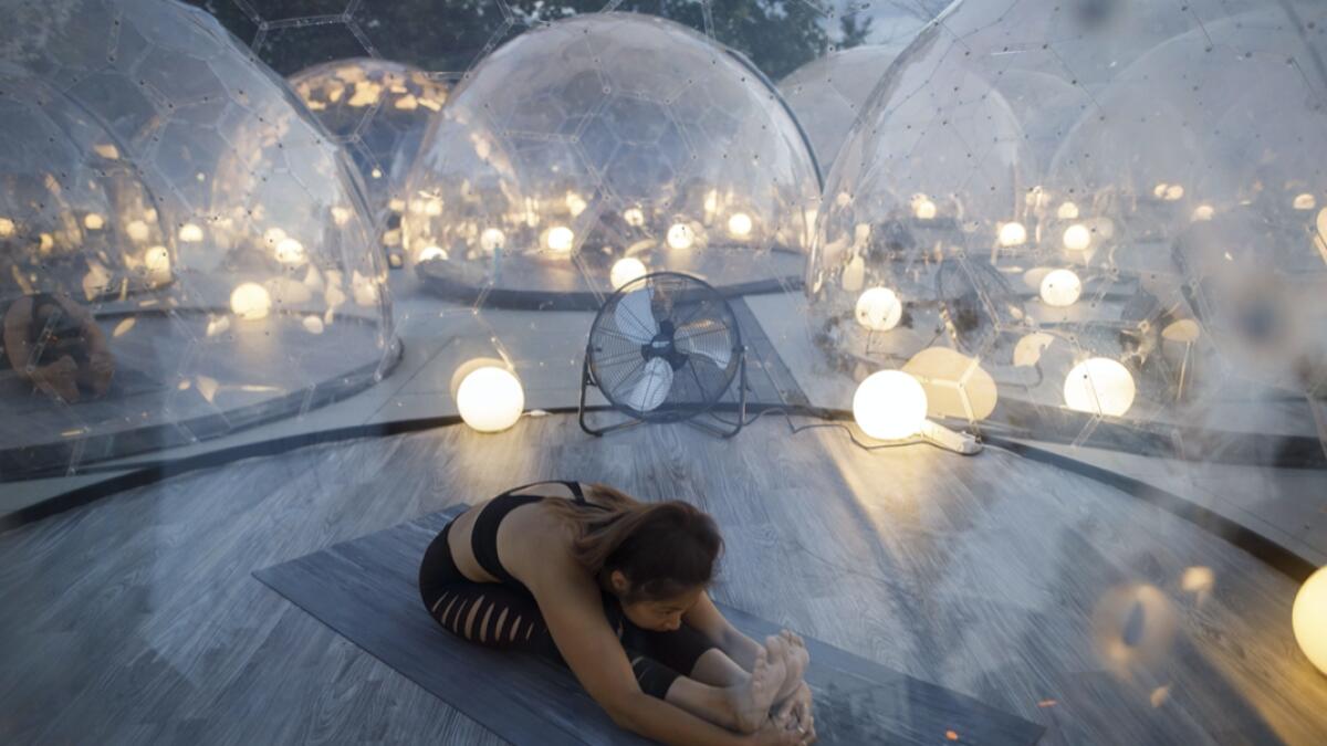An outdoor yoga class at Hotel X, inside domes to comply with social distancing measures to control the spread of Covid-19 in Toronto, Canada. As Canada begins to reopen its economy following Covid-19 shutdowns, gyms and fitness centres still remain closed as they determine how to comply with social distancing measures. Photo:  AFP