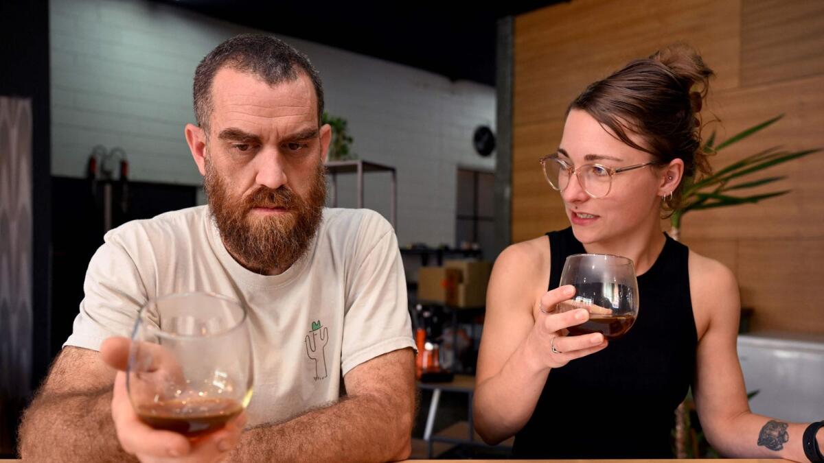 Proud Mary owner Nolan Hirte (L) and project manager Brodie Roberts (R) sampling a brew of coffee at their cafe in Melbourne. — AFP