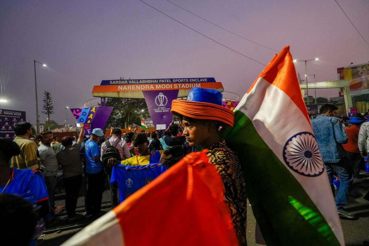 A young man sells Indian flags outside the Narendra Modi Stadium in Ahmedabad on Saturday. — PTI