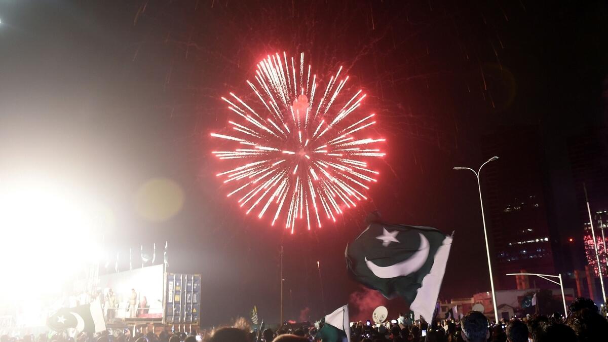 People watch fireworks on a street during Independence Day celebrations in Karachi on August 14, 2020, as Pakistan celebrates its 74th anniversary of independence from British rule.  Photo: AFP