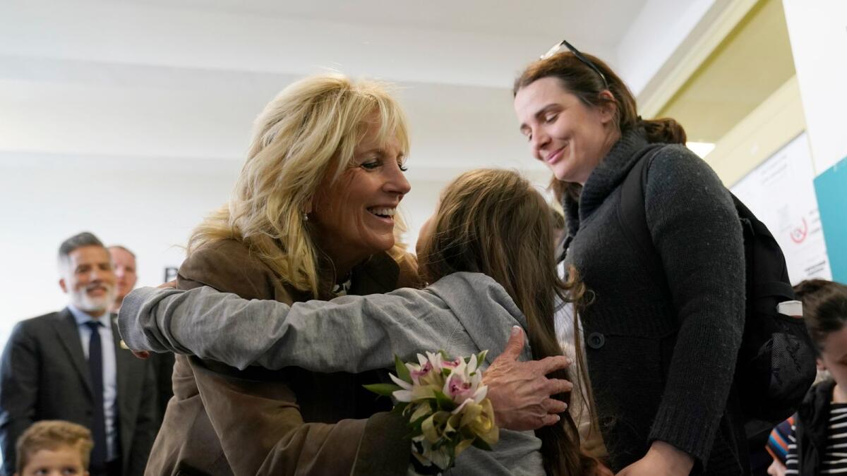 US First Lady Jill Biden gets a hug from Ukrainian refugee Yulie Kutocha, 7, as her mother Victorie Kutocha (R) watches at a city-run refugee center in Kosice, Slovakia. AFP