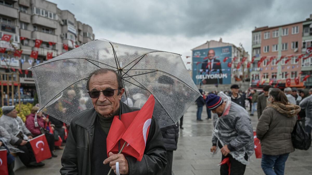 A Supporter holds Turkish national flag during a rally of Turkey's Republican People's Party (CHP) Chairman and Presidential candidate Kemal Kilicdaroglu in Canakkale, western Turkey, on Tuesday. — AFP