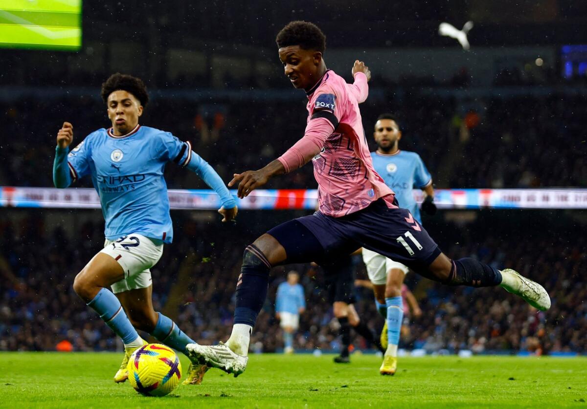 Everton's Demarai Gray (right) goes for a shot against Manchester City. — Reuters