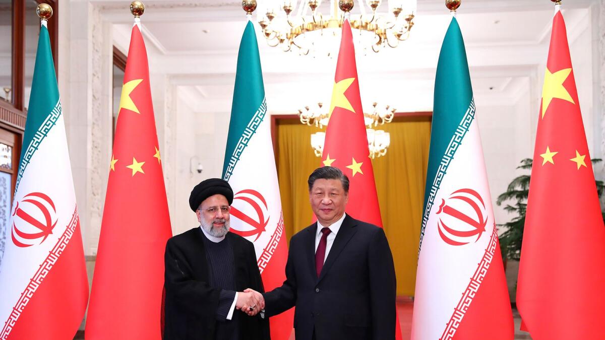 President Ebrahim Raisi shakes hands with his Chinese counterpart Xi Jinping in an official welcoming ceremony in Beijing, on Tuesday. –AP