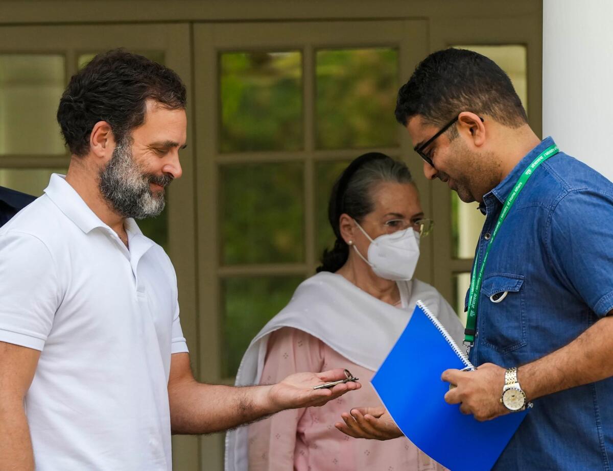 Congress leader Rahul Gandhi hands over the keys of 12, Tughlak Lane bungalow to a CPWD official after vacating the bungalow following his disqualification as a Lok Sabha MP in New Delhi on Saturday. — PTI