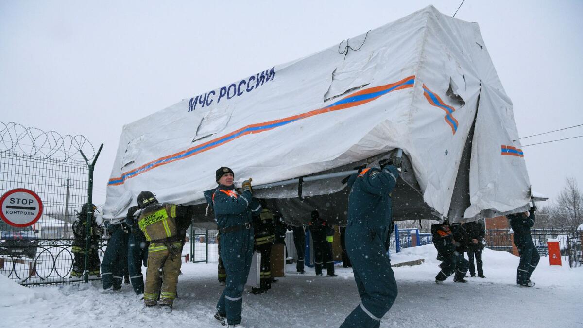 Specialists of Russian Emergencies Ministry carry a tent during a rescue operation following a fire in the Listvyazhnaya coal mine in the Kemerovo region last month. — Reuters file