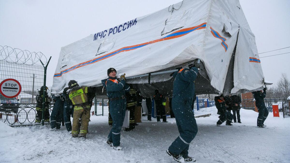 Specialists of Russian Emergencies Ministry carry a tent during a rescue operation following a fire in the Listvyazhnaya coal mine in the Kemerovo region last month. — Reuters file