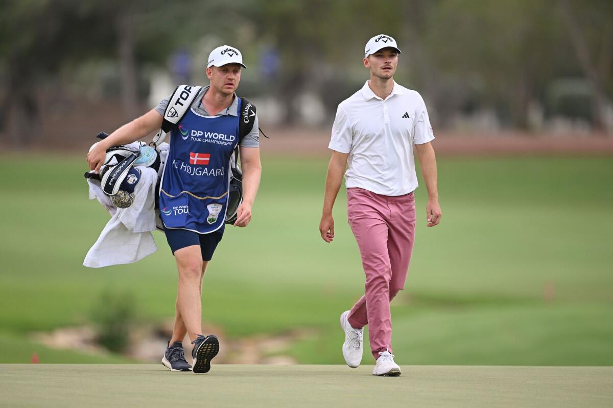 Nicolai Hojgaard of Denmark walks with his caddie Christian Christensenon the 18th green during Day One of the DP World Tour Championship. — Supplied photo