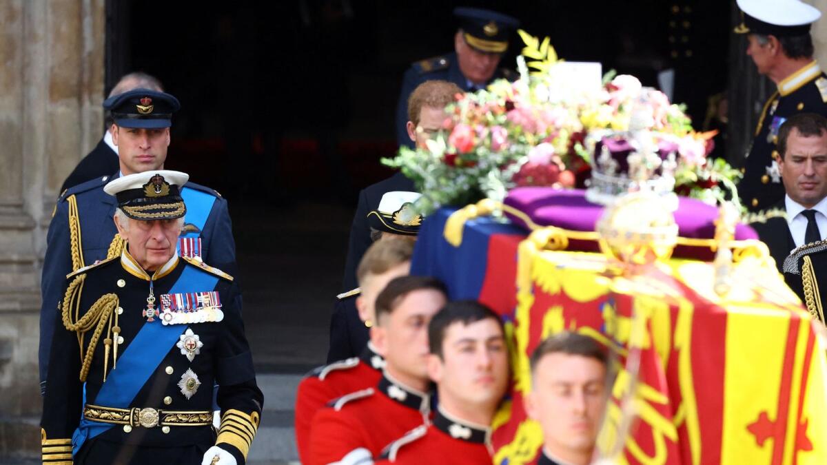 Britain's King Charles and William, Prince of Wales walk as the coffin of Britain's Queen Elizabeth is carried out of Westminster Abbey after the service.