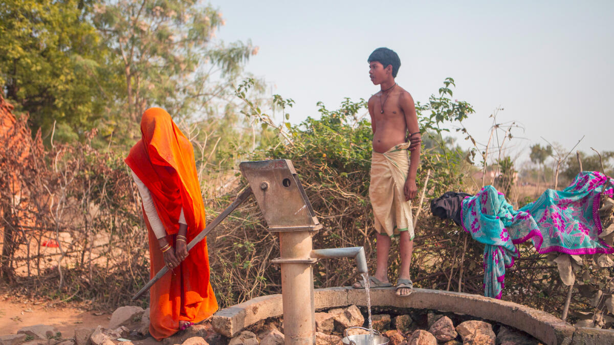 A woman draws water from a communal pump in a village in the Indian state of Madhya Pradesh. 