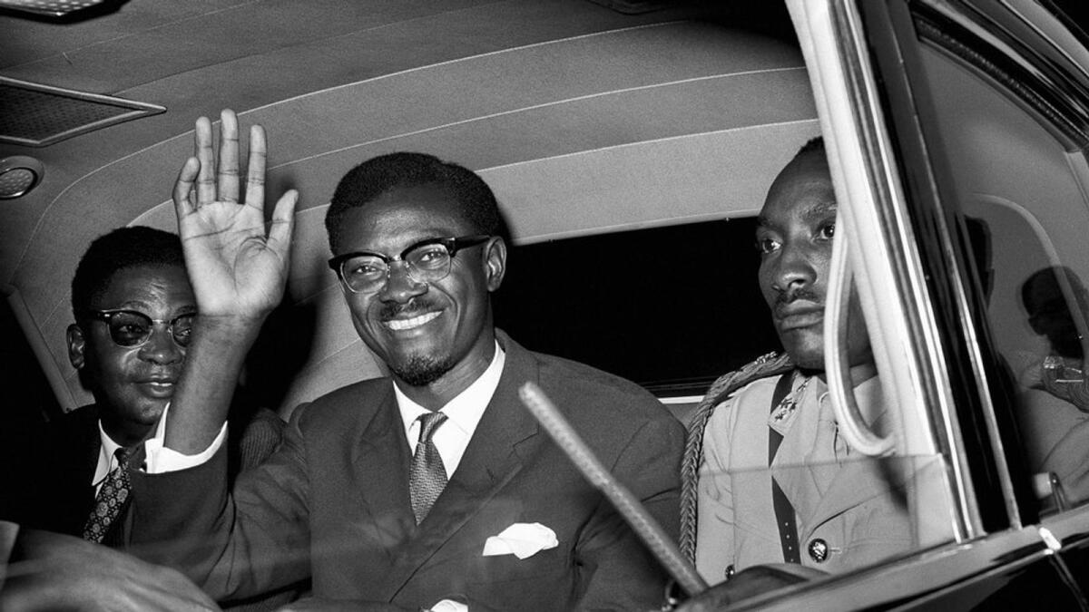 In this July 24, 1960 file photo, Congo Premier Patrice Lumumba waves as he sits in car for the drive from Idlewild Airport, New York after his arrival from Europe to speak to the United Nations Security Council. — AP file