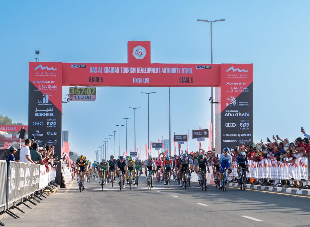 Riders cross the finish line to complete the fifth stage on Friday. — Supplied photo