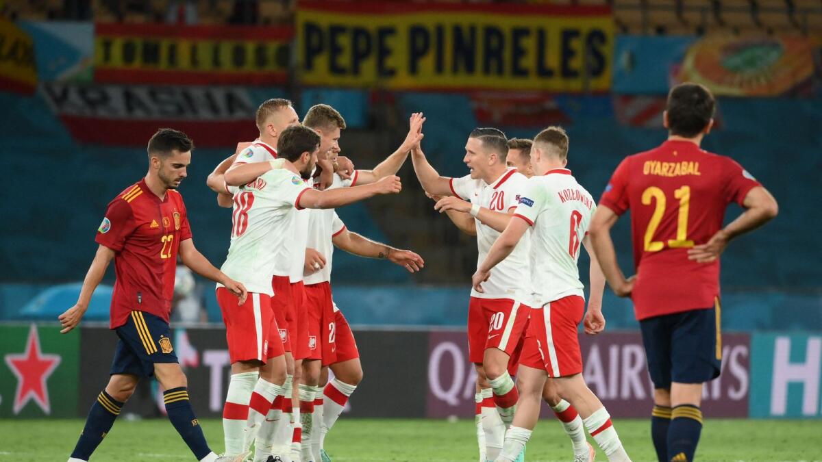 Poland's players celebrate at the end of the Euro 2020 Group E match against Spain . — AFP
