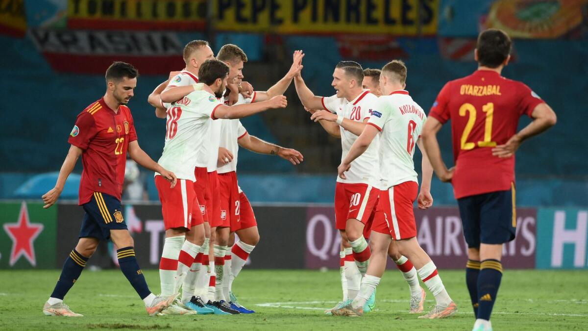 Poland's players celebrate at the end of the Euro 2020 Group E match against Spain . — AFP