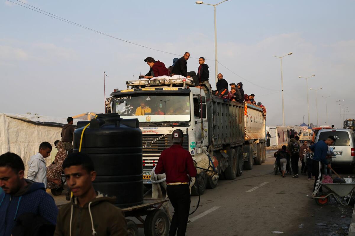 Palestinians fleeing the Israeli bombardment of the Gaza Strip arrive in Rafah on Wednesday. — AP
