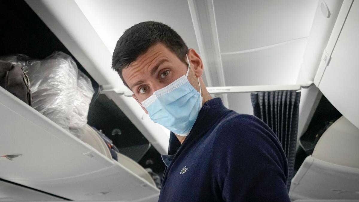 Novak Djokovic prepares to take his seat on a plane in Dubai. (AP)