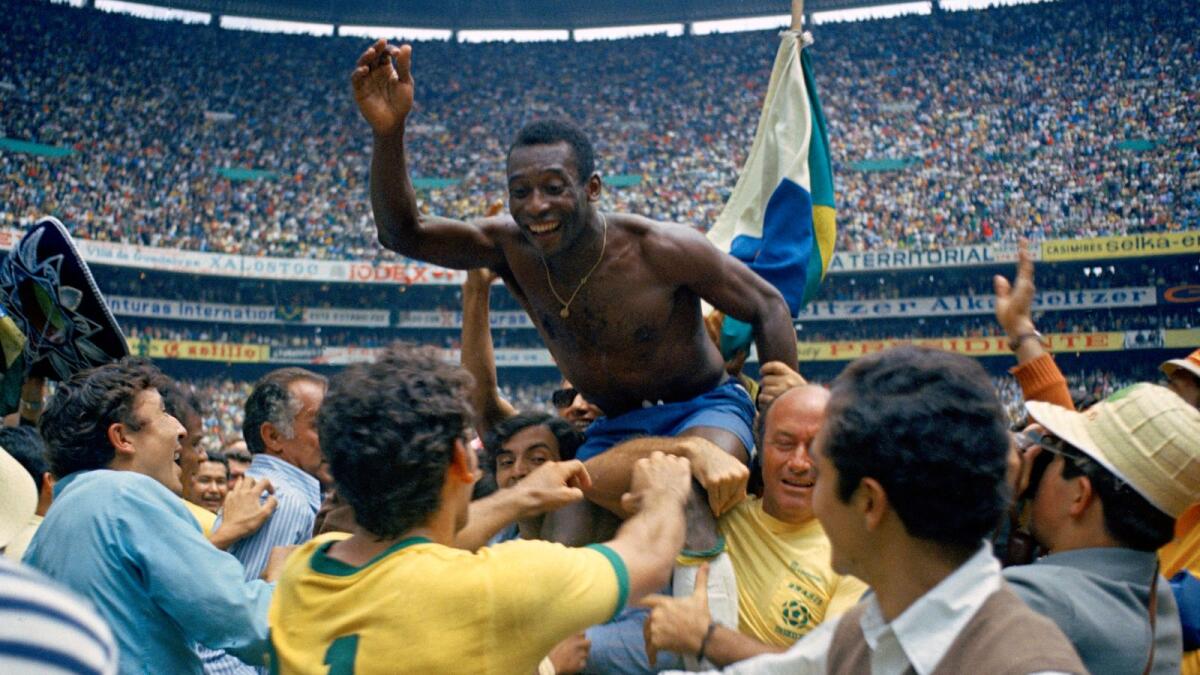 Brazil's Pele is hoisted on the shoulders of his teammates after Brazil won the 1970 World Cup final against Italy in Mexico City's Estadio Azteca. — AP file