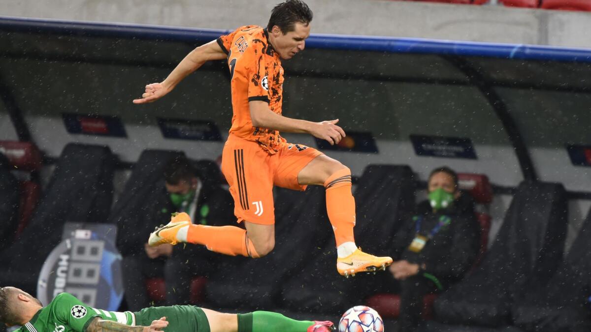 Juventus' Italian forward Federico Chiesa is tackled by Ferencvaros' Hungarian forward Gergo Lovrencsics during the Uefa Champions League Group G match.