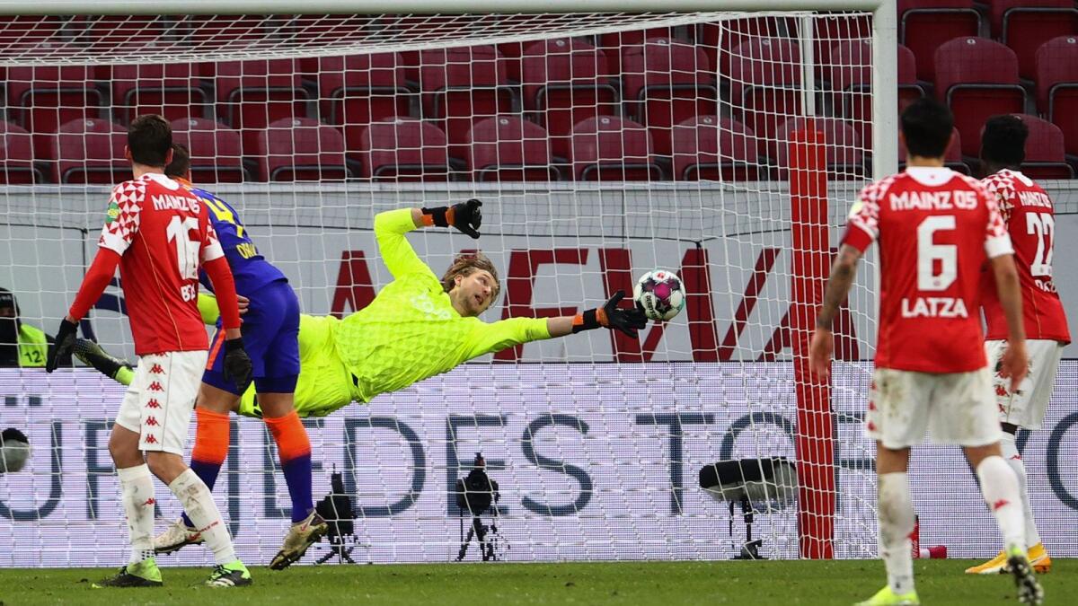 Mainz' German goalkeeper Robin Zentner (centre) jumps to save the ball during the German first division Bundesliga football match against RB Leipzig. — AFP