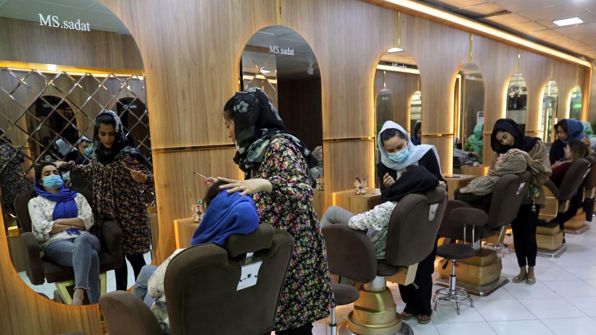 Makeup artists while putting makeup on a customers at Sadat's Beauty Salon in Kabul, Afghanistan on Sunday.