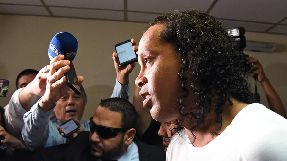 Ronaldinho and his brother Assis (unseen) have been detained since early March for allegedly entering the South American country with fake passports. -- AFP file