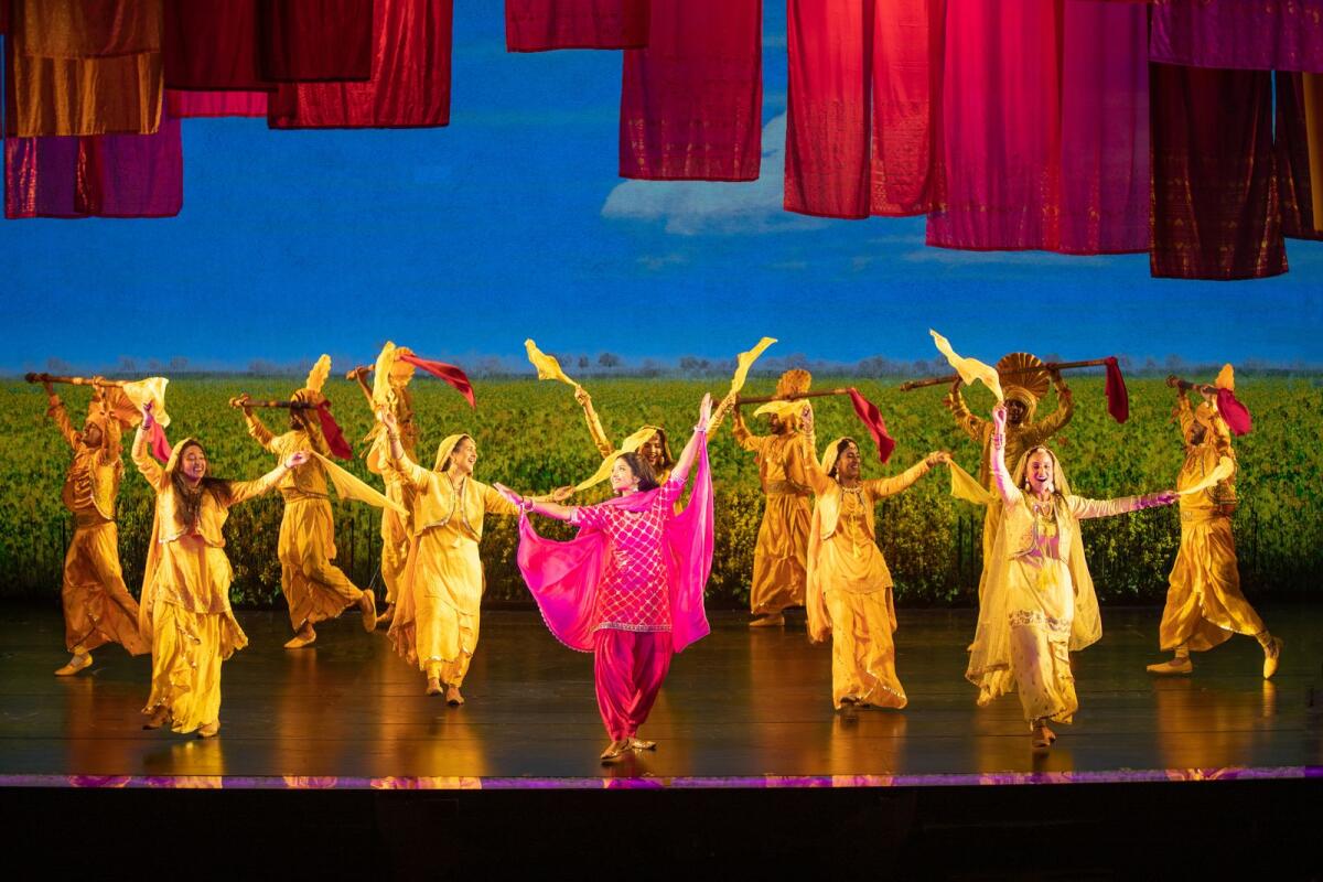 Shoba Narayan, with ensemble members, in “Come Fall in Love — The DDLJ Musical.”