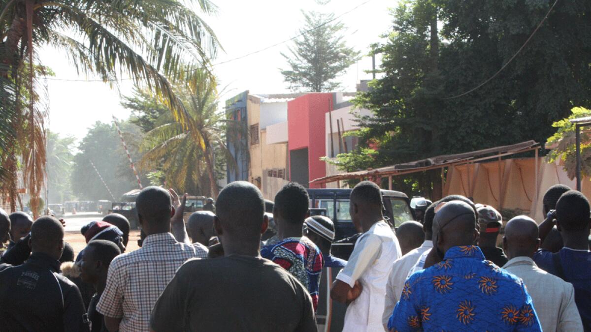 Onlookers gather near the Radisson Blu hotel after gunmen stormed the building in Bamako.