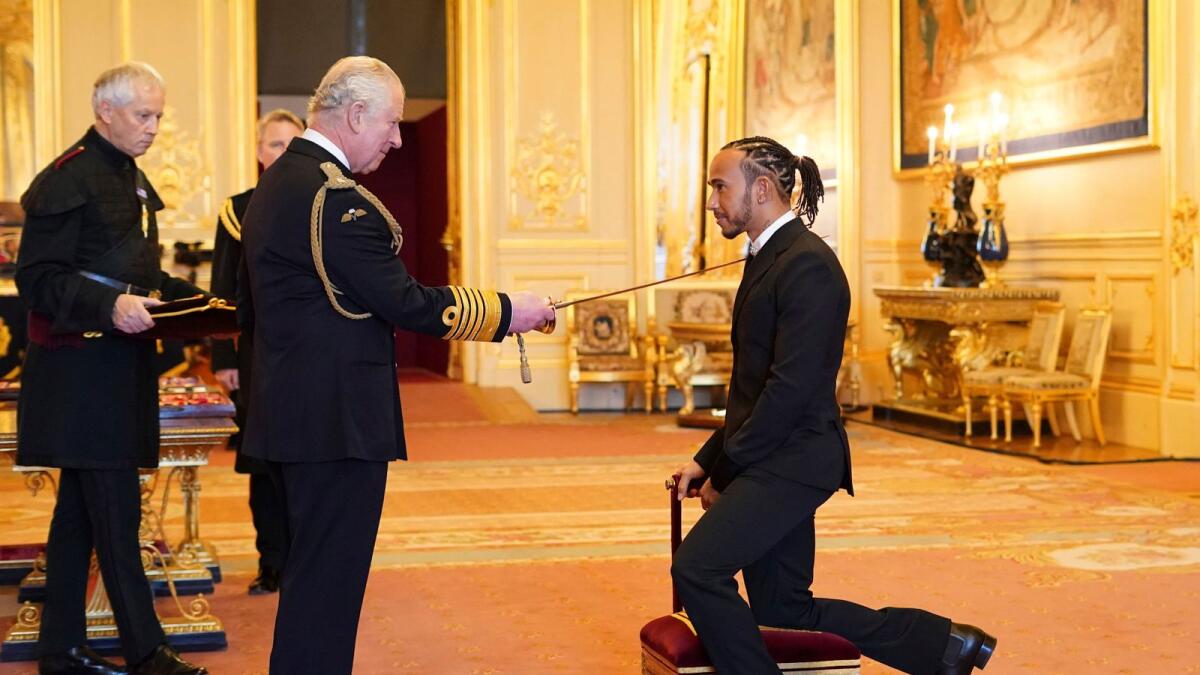 Lewis Hamilton is made a Knight Bachelor by Britain's Prince Charles at Windsor Castle on Wednesday. — AP