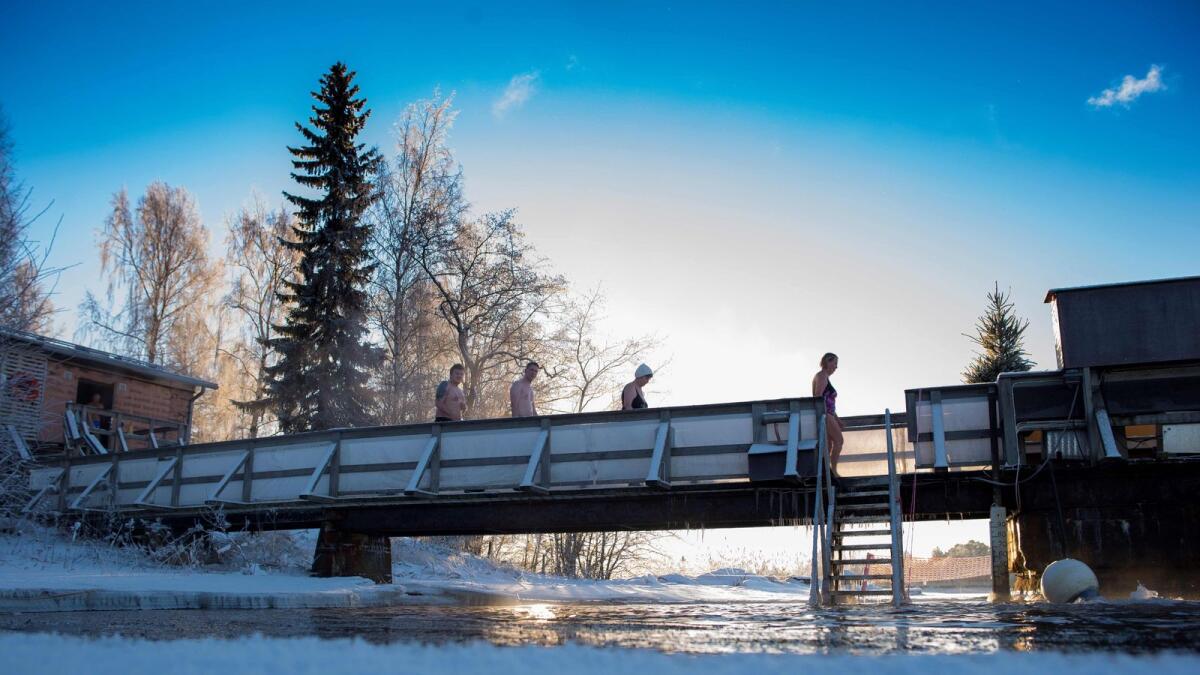 Finns take a dip in an unfrozen hole of water after a sauna session in Vaasa, as air temperature is -17C and water is +1C.