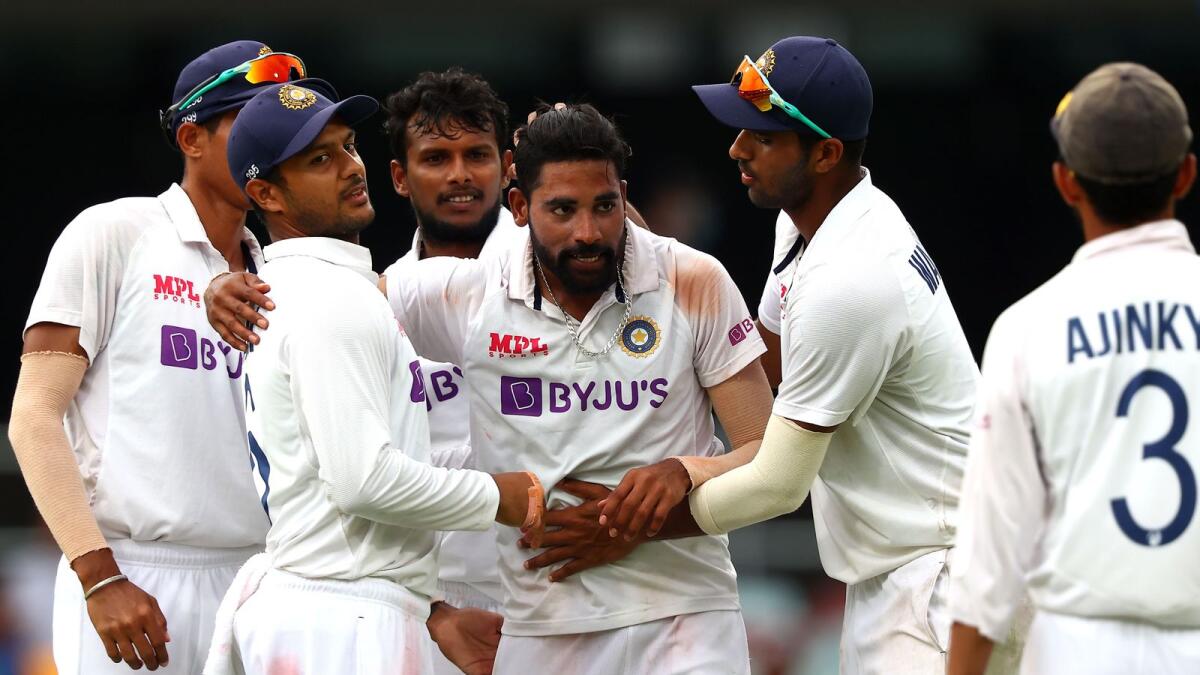 India's paceman Mohammed Siraj (centre) celebrates his fifth wicket with teammates on day four of the fourth Test against Australia. — AFP