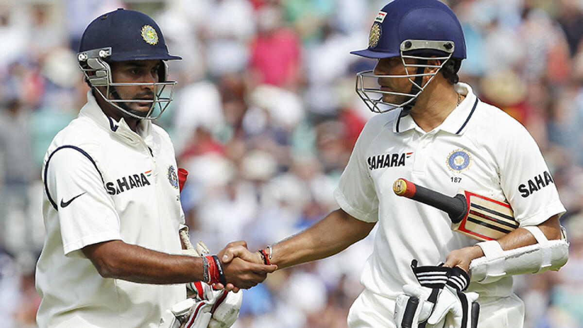 India's Amit Mishra (left) gets a handshake from team-mate Sachin Tendulkar after scoring a valiant knock of 84 runs on the fifth day of the fourth Test against England at The Oval , on August 22, 2011. -- AFP file