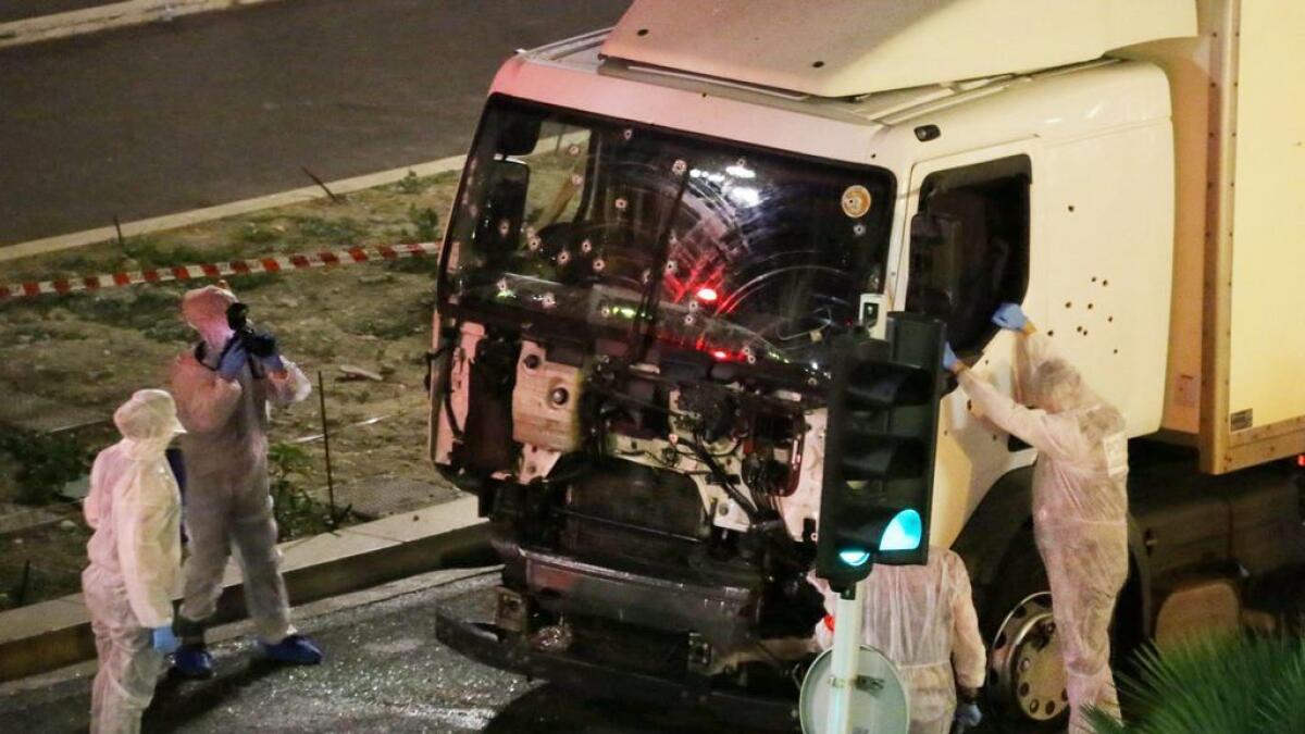 Authorities investigate a truck after it plowed through Bastille Day revelers in the French resort city of Nice, France, 