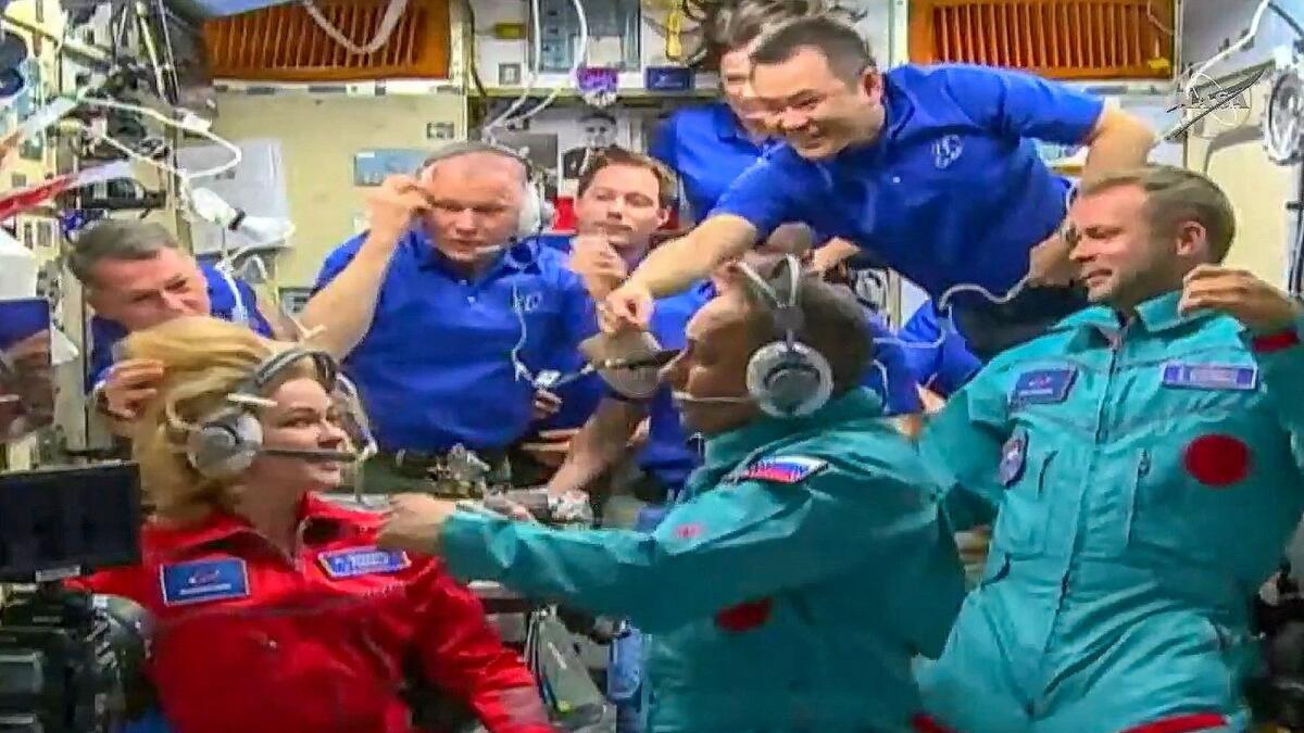 Crew members, actress Yulia Peresild (left), cosmonaut Anton Shkaplerov (centre) and film director Klim Shipenko entering the International Space station. Photo: AFP