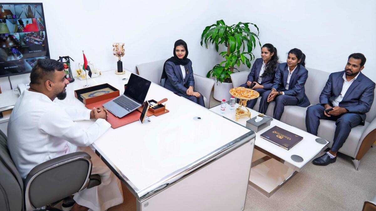 Shanid bin Mohammed interacting with JBS team members in his office