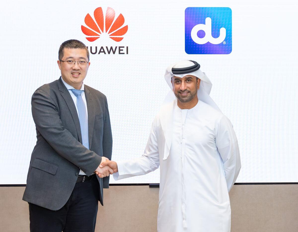 Jiawei Liu, CEO of Huawei UAE, and Fahad Al Hassawi, CEO of du, shaking hands after signing the MoU on Sustainability and Green Development Programme. — Supplied photo  