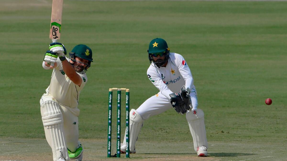 South Africa's Dean Elgar plays a shot as Pakistan's wicketkeeper Mohammad Rizwan watches during the first day of the first cricket Test at the National Stadium in Karachi on Tuesday. — AFP