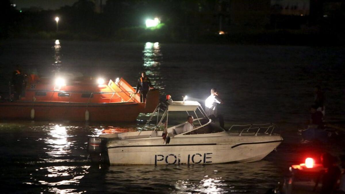 Police boats search for victims of a boat accident on the River Nile in the Warraq area of Giza, Egypt.